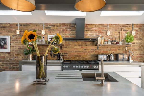 polished concrete kitchen worktops with exposed brick wall