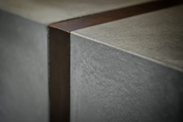 Close-up of solid cast concrete texture reception desk edge