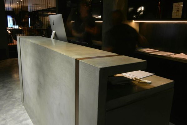 Polished concrete reception counter front with integral cast top detail