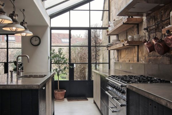Polished concrete worktops and island rustic Bath stone wall