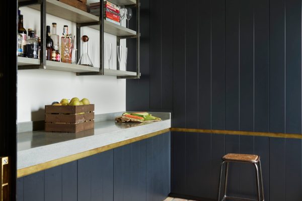 Polished concrete worktop with dark cabinetry in industrial utility room Cheshire kitchen
