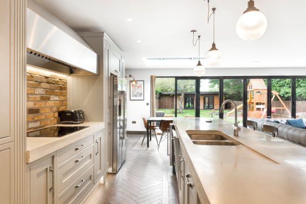 Board-formed concrete worktops in bright contemporary kitchen