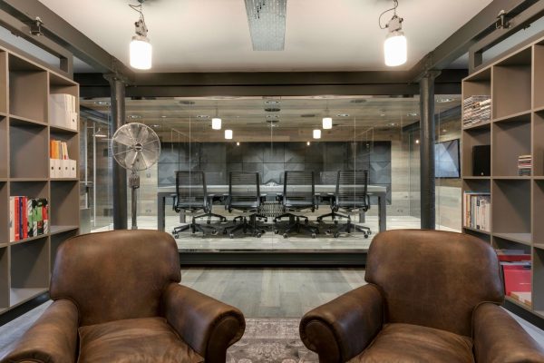Concrete meeting table viewed through glass office partition